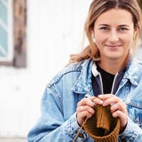A knitted hooded cowl that can be worn two ways -- as a hood or dropped as a cowl around the neck.