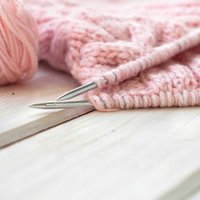A little of knitting's history, and why a garter stitch scarf remains the right first project.